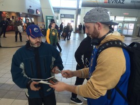 Winnipeg Blue Bombers quarterback Matt Nichols signs an autograph for fan Fred Clearihue at the Regina International Airport on Monday, March 20, 2017. Nichols is one of 60 players taking part in CFL Week in the city.