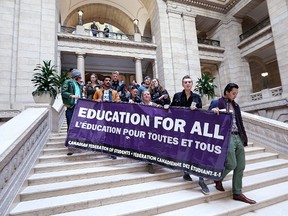 Canadian Federation of Students protesters are escorted from the Manitoba Legislative Building in Winnipeg on Mon., March 20, 2017. Kevin King/Winnipeg Sun/Postmedia Network