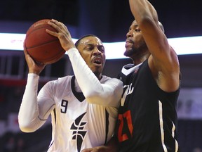 Doug Herring Jr. of the London Lightning tries to push through Orangeville's Da'Quan Cook during the first half of the NBL Canada game at Budweiser Gardens on Monday March 20, 2017. (MIKE HENSEN, The London Free Press)