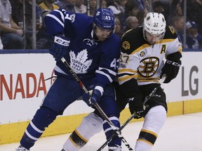 Maple Leafs centre Nazem Kadri (43) and Bruins centre Patrice Bergeron (37) battle for the puck during NHL action at the Air Canada Centre in Toronto on Monday March 20, 2017. (Veronica Henri/Toronto Sun)