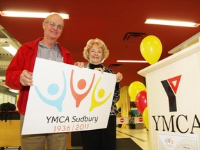 Sudbury YMCA volunteers Gary Gray and Millie Facca display a new 75th anniversary logo unveiled at the launch of YMCA Sudbury's 75th anniversary celebrations on Tuesday, March 8, 2011.
