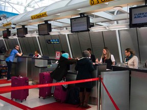 Workers help passengers at the Turkish Airlines ticket counter March 21, 2017 at John F. Kennedy International Airport in New York. (DON EMMERT/Getty Images)