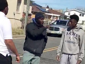 A man breaks up a fight between two teens in New Jersey, (Facebook screengrab)