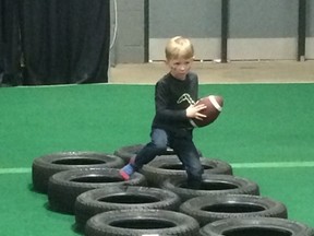 A young boy works out like a pro at Fan Fest, part of CFL Week in Regina on Tuesday, March 21, 2017. (Ted Wyman/Postmedia Network)
