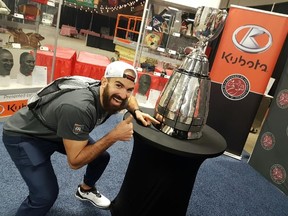 Redblacks receiver Brad Sinopoli shows his approval for his name etched on the Grey Cup by giving a thumbs up. (Postmedia Network)