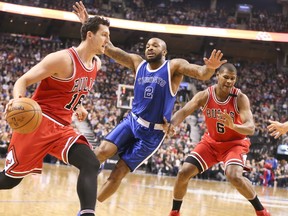 Raptors forward P.J. Tucker (centre) defends with Bulls forwards Paul Zipser (16) and Cristiano Felicio (6) on the court during NBA action in Toronto on Tuesday, March 21, 2017. (Veronica Henri/Toronto Sun)