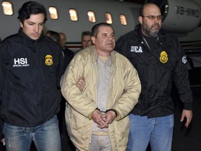 In this Jan. 19, 2017 file photo provided U.S. law enforcement, authorities escort Joaquin "El Chapo" Guzman, center, from a plane to a waiting caravan of SUVs at Long Island MacArthur Airport, in Ronkonkoma, N.Y. U.S. prosecutors and lawyers for infamous drug lord Guzman are sparring over his tough jail conditions. (U.S. law enforcement via AP, File)