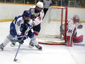 Sudbury Nickel Capital Wolves`Parker Savard fends off North Bay Trappers` Eric Mondoux during Game 4 of the Great North Midget League championship final at Gerry McCrory Countryside Sports Complex on Tuesday night. Gino Donato/The Sudbury Star