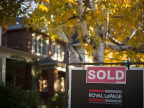 A real estate sold sign hangs in front of a west-end Toronto property. THE CANADIAN PRESS