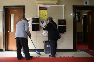 A woman gets toilet paper from a dispenser next to two unused automatic toilet paper dispensers that use facial recognition technology at a public toilet at the Temple of Heaven in Beijing on March 21, 2017. 
A years-long crime spree by Chinese toilet paper thieves may have reached the end of its roll after park officials in southern Beijing installed facial recognition technology to flush out bathroom bandits. WANG ZHAO/AFP/Getty Images