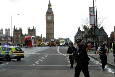 Police secure the area on the south side of Westminster Bridge close to the Houses of Parliament in London, Wednesday, March 22, 2017. The leader of Britain's House of Commons says a man has been shot by police at Parliament. David Liddington also said there were "reports of further violent incidents in the vicinity." London's police said officers had been called to a firearms incident on Westminster Bridge, near the parliament. Britain's MI5 says it is too early to say if the incident is terror-related. (AP Photo/Matt Dunham) ORG XMIT: LON110