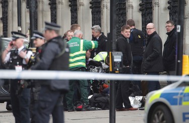 Emergency services work at the scene of a crashed car close to the Houses of Parliament, London, Wednesday, March 22, 2017. London police say officers called to 'firearms incident' on Westminster Bridge, near Parliament. The leader of Britain's House of Commons says a man has been shot by police at Parliament. David Liddington also said there were "reports of further violent incidents in the vicinity."  London's police said officers had been called to a firearms incident on Westminster Bridge, near the parliament. Britain's MI5 says it is too early to say if the incident is terror-related.(Yui Mok/PA via AP) ORG XMIT: LON821