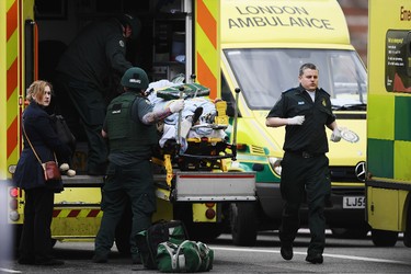 LONDON, ENGLAND - MARCH 22:  A member of the public is moved into an ambulance by emergency services near Westminster Bridge and the Houses of Parliament on March 22, 2017 in London, England. A police officer has been stabbed near to the British Parliament and the alleged assailant shot by armed police. Scotland Yard report they have been called to an incident on Westminster Bridge where several people have been injured by a car.  (Photo by Carl Court/Getty Images)