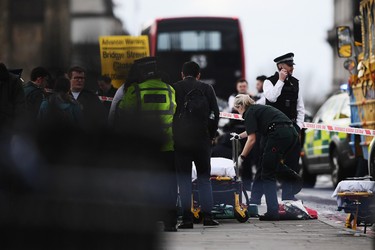 LONDON, ENGLAND - MARCH 22:  Medical staff in attendance near Westminster Bridge on March 22, 2017 in London, England. A police officer has been stabbed near to the British Parliament and the alleged assailant shot by armed police. Scotland Yard report they have been called to an incident on Westminster Bridge where several people have been injured by a car.  (Photo by Carl Court/Getty Images)