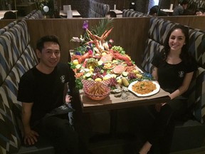 Captain's Boil manager Victor Tsang and server Alyssa Santos show off some of the fresh seafood available at the restaurant chain's first London location. (Hank Daniszewski, The London Free Press)