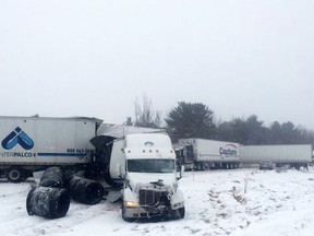Tractor-trailers sit off the road after a crash involving at least 30 vehicles on Highway 401 near Brockville caused a chemical spill in March. (Photo courtesy XBR Brockville on Twitter)
