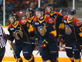 The Erie Otters' Kyle Pettit, center, heads back to the bench with his line mates after scoring the game opener on a power play against the Owen Sound Attack's goalie Michael McNiven during Ontario Hockey League first period action at the Lumley Bayshore in Owen Sound, Ont. on Saturday, December 3, 2016. (Postmedia News file photo)