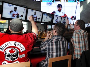Team Canada fans cheer on the Canadian Olympic men's hockey team at the Shark Club Sports Bar and Grill in Calgary on Feb. 19, 2014. (Stuart Dryden/Postmedia Network/Files)