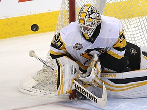Penguins goaltender Matt Murray squeezes against the post to make a save against the Jets during NHL action in Winnipeg on March 8, 2017. (Kevin King/Postmedia Network)