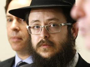 Rabbi Moshe Steiner of Uptown Chabad listens to Toronto Mayor John Tory speak on fighting antisemitism at 32 Division in North York, One the left is B'nai Brith Canada CEO Michael Mostyn on Wednesday February 22, 2017. (Michael Peake/Toronto Sun/Postmedia Network)