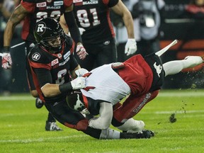 Redblacks defensive back Antoine Pruneau (left) brings down a Stampeder. Pruneau thinks his team has a brutal schedule. (Craig Robertson/Postmedia Network)