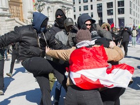 Opposing groups of protesters clash during a demonstration regarding motion M-103 in Montreal, Saturday, March 4, 2017. (THE CANADIAN PRESS/PHOTO)