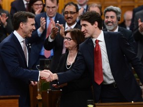 Prime Minister Justin Trudeau shakes hands with Minister of Finance Bill Morneau after he delivered the federal budget in the House of Commons on Parliament Hill in Ottawa, Wednesday March 22, 2017. (THE CANADIAN PRESS/PHOTO)