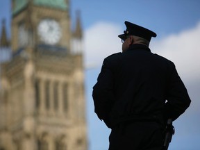 A House of Commons security guard who helped keep the prime minister safe during the attack by Michael Zehaf-Bibeau in 2015 stands on Parliament Hill in this Oct. 20, 2015 file photo. (POSTMEDIA NETWORK/FILES)