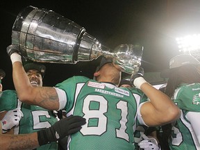 Saskatchewan Roughriders Geroy Simon kisses the Grey Cup after beating the Hamilton Tiger-Cats in the 101st CFL Grey Cup in Regina, Sask., on Sunday November 24, 2013.