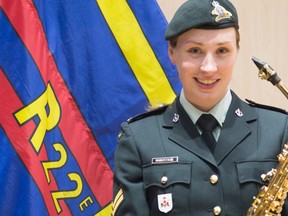 Cpl. Sarah Robertson is pictured with the flag of the Royal 22e RŽgiment Band. The Sarnia native and saxophonist is playing with the band at Vimy Ridge April 9th for the 100th anniversary commemoration of the historic First World War Battle.  (Submitted)