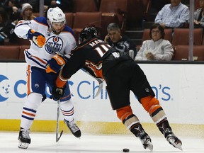 Edmonton Oilers left wing Patrick Maroon, left, looks to get around Anaheim Ducks defenseman Josh Manson during the first period of an NHL hockey game in Anaheim, Calif., Wednesday, March 22, 2017.