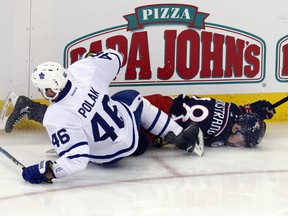 Toronto Maple Leafs defenceman Roman Polak, left, checks Columbus Blue Jackets forward Oliver Bjorkstrand during the third period in Columbus, Ohio, Wednesday, March 22, 2017. Polak was called for boarding and a game misconduct. (AP Photo/Paul Vernon)