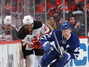 Tyler Bozak #42 of the Toronto Maple Leafs moves the puck away from Devante Smith-Pelly #25 of the New Jersey Devils during the first period at the Prudential Center on January 6, 2017 in Newark, New Jersey. Bruce Bennett/Getty Images)