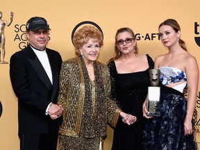 Todd Fisher, actress Debbie Reynolds, recipient of the Screen Actors Guild Life Achievement Award, actresses Carrie Fisher and Billie Lourd pose in the press room at the 21st Annual Screen Actors Guild Awards at The Shrine Auditorium on January 25, 2015 in Los Angeles, California. (Photo by Ethan Miller/Getty Images)