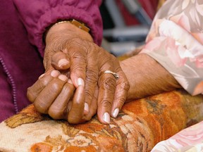 In this April 1, 2005 file photo, an 81-year-old woman holds the hand of her 100-year-old mother in Tuscaloosa, Ala. A survey conducted in late 2016 finds many pessimistic feelings held by people earlier in life take an optimistic turn as they move toward old age. Even hallmark concerns of old age _ about declining health, lack of independence and memory loss _ lessen as Americans age. (Dan Lopez/The Tuscaloosa News via AP)