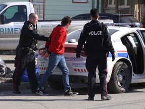 Greater Sudbury Police arrest a male on Albert Street following a weapons complaint. At least five people were taken into custody at the scene. John Lappa/The Sudbury Star/Postmedia Network