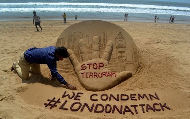 Indian sandartist Sudarsan Pattnaik gives the final touches to a sand sculpture on Puri Beach, some 65kms from Bhubaneswar on March 23, 2017, the day after an attack in London. STR/AFP/Getty Images