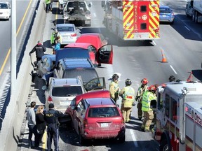 While dramatic looking there were no serious injuries in this multi-car crash that blocked two lanes of the eastbound Queensway and backed cars up for kilometres. JULIE OLIVER / POSTMEDIA