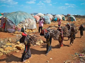 Women carry firewood on March 15, 2017 as they walk back to a makeshift camp on the outskirts of Baidoa, in the southwestern Bay region of Somalia, where thousands of internally displaced people arrive daily after they fleeing the parched countryside.
The United Nations is warning of an unprecedented global crisis with famine already gripping parts of South Sudan and looming over Nigeria, Yemen and Somalia, threatening the lives of 20 million people. For Somalis, the memory of the 2011 famine which left a quarter of a million people dead is still fresh.
TONY KARUMBATONY KARUMBA/Getty Images