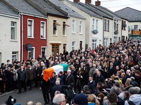 The coffin of Martin McGuinness is carried to St Columba’s Church in Derry, Northern Ireland, Thursday, March 23, 2017. (AP Photo/Alastair Grant)
