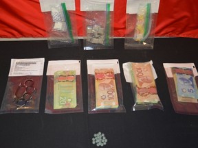 A search of the vehicle subsequent to the arrest was completed and police seized; 23 Fentanyl pills, Cocaine, brass knuckles and over $10,000.00 in Canadian Currency. Photo supplied/RCMP