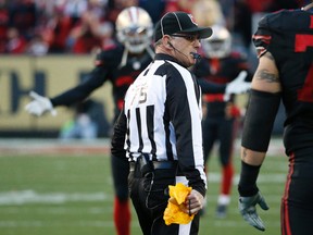 NFL side judge Rob Vernatchi (75) holds a penalty flag during second half NFL action between the 49ers and Cardinals in Santa Clara, Calif., on Nov. 29, 2015. (Tony Avelar/AP Photo/Files)