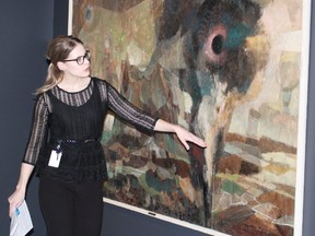 Assistant curator Sonya Blazek describes a York Wilson cartoon at the Judith & Norman Alix Art Gallery Thursday. Imperial Oil donated a collection of sketches and cartoons from the famed Canadian muralist to the downtown Sarnia art gallery. Barbara Simpson/Sarnia Observer/Postmedia Network