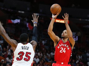 Raptors guard Norman Powell (right) shoots as Heat forward Willie Reed (left) defends during second quarter NBA action in Miami on Thursday, March 23, 2017. (Joe Skipper/AP Photo)