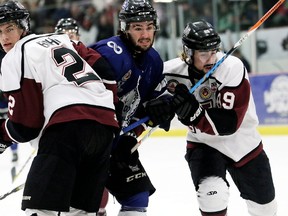 London Nationals? Michael Andlauer is sandwiched by Maroons Dakota Bohn, left, and Blair Derynck during the first period of Game 5 of the GOJHL Western Conference semifinal at Chatham Memorial Arena on Thursday night. The Nats clinched the series with a 6-1 victory.  (MARK MALONE, Postmedia News)