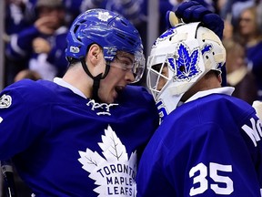 Toronto Maple Leafs centre Auston Matthews (34) and Toronto Maple Leafs goalie Curtis McElhinney (35) celebrate the Leafs' win following third period NHL action against the New Jersey Devils, in Toronto on Thursday, March 23, 2017. THE CANADIAN PRESS/Frank Gunn