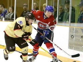 Rayside-Balfour Canadians' Cayse Ton battles for the puck with a member of the Blind River Beavers during NOJHL Game 4 playoff action at Chelmsford Arena on Thursday night. Ton scored all three goals for the Canadians in a series-tying 3-2 victory. Gino Donato/The Sudbury Star