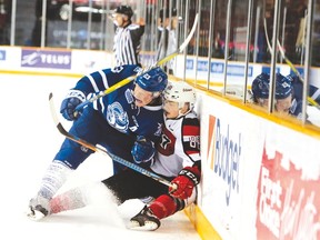 Steelheads’ Stefan LeBlanc takes 67’s Drake Rymsha into the boards in a game that turned around Mississauga’s fortunes. The teams meet in Game 1 of their best-of-seven series on Friday. (David Kawai photo)