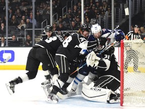 Paul LaDue (centre) of the Los Angeles Kings and Joel Armia of the Winnipeg Jets fall onto Kings goalie Ben Bishop at Staples Center in Los Angeles last night. The Kings won 5-2. (Getty Images)