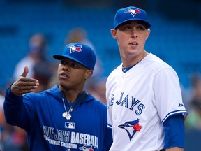 Toronto Blue Jays pitchers Marcus Stroman, left, and Aaron Sanchez talk before the Blue Jays take on the Boston Red Sox in Toronto on Tuesday, July 22, 2014. (THE CANADIAN PRESS/Nathan Denette)